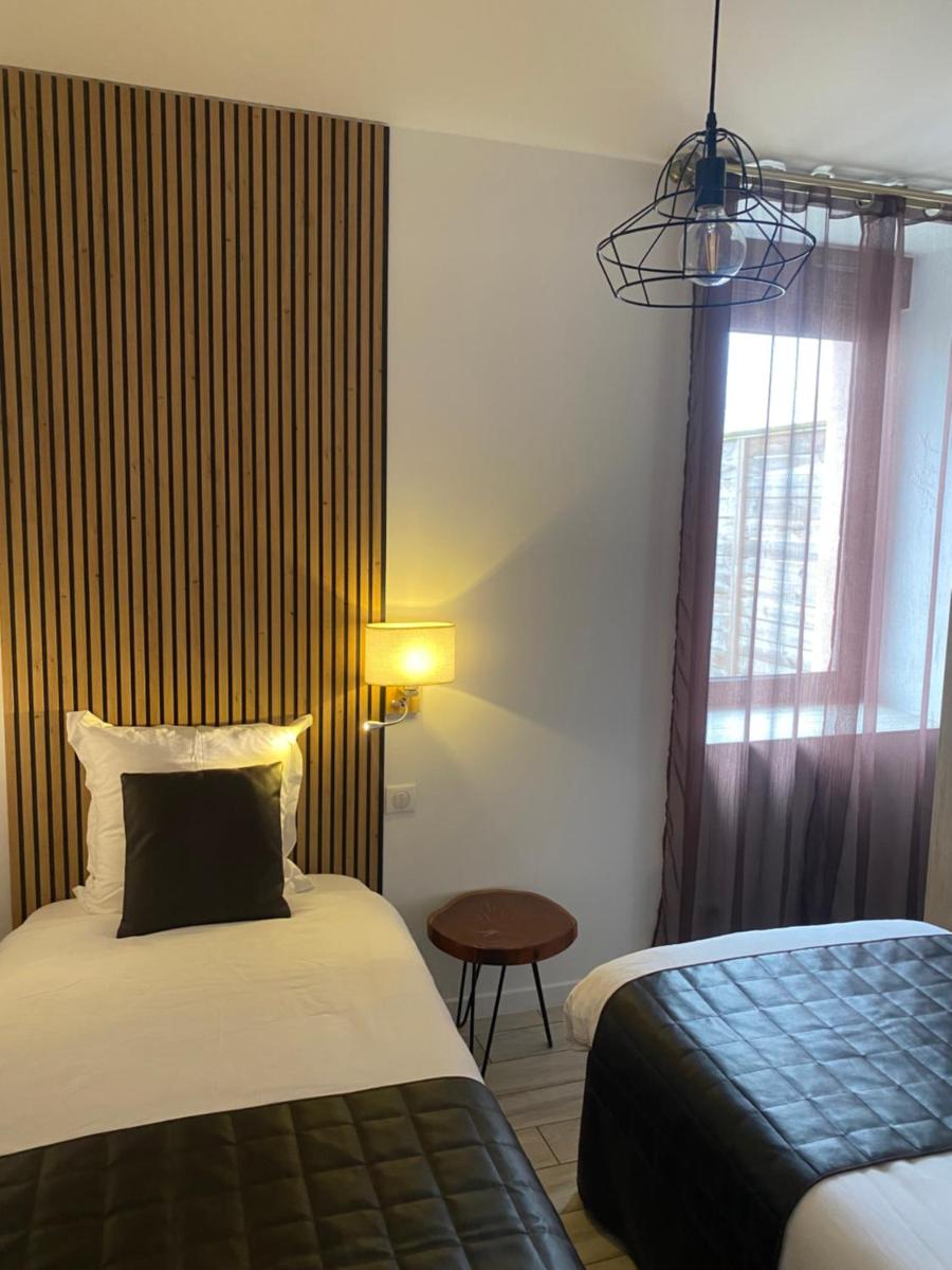 Un ou plusieurs lits dans un hébergement de l'établissement Le Moulin d'Oscar & Spa - Mulhouse Nord