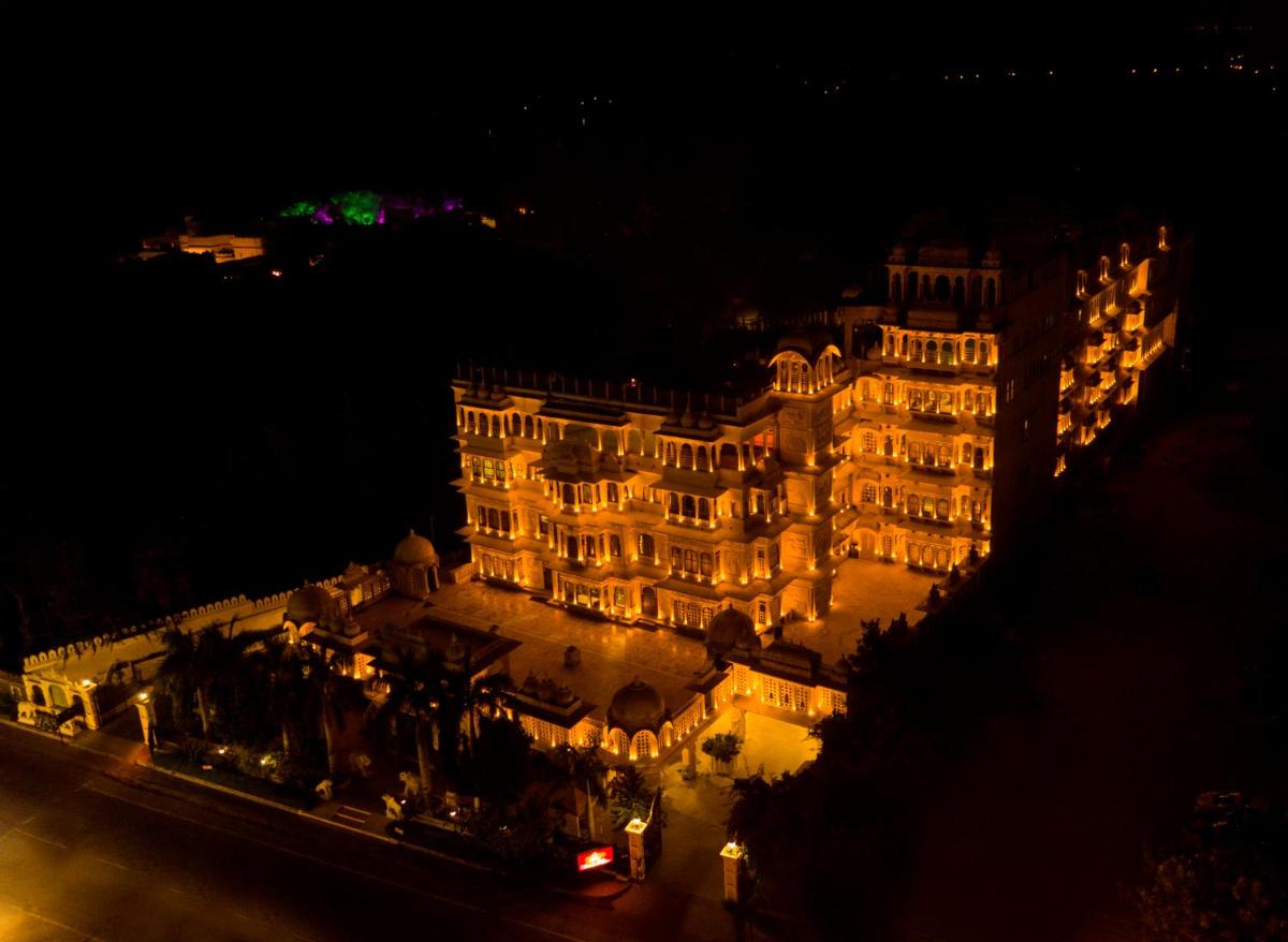 a large building at night with lights on it at Chunda Palace in Udaipur