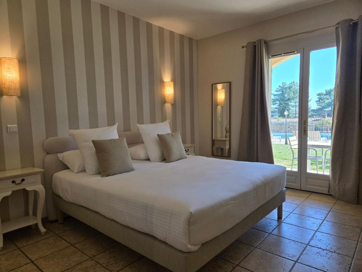 Un ou plusieurs lits dans un hébergement de l'établissement CÉRÈS - Boutique-Hôtel & Spa