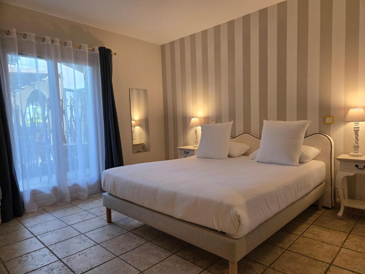 Un ou plusieurs lits dans un hébergement de l'établissement CÉRÈS - Boutique-Hôtel & Spa