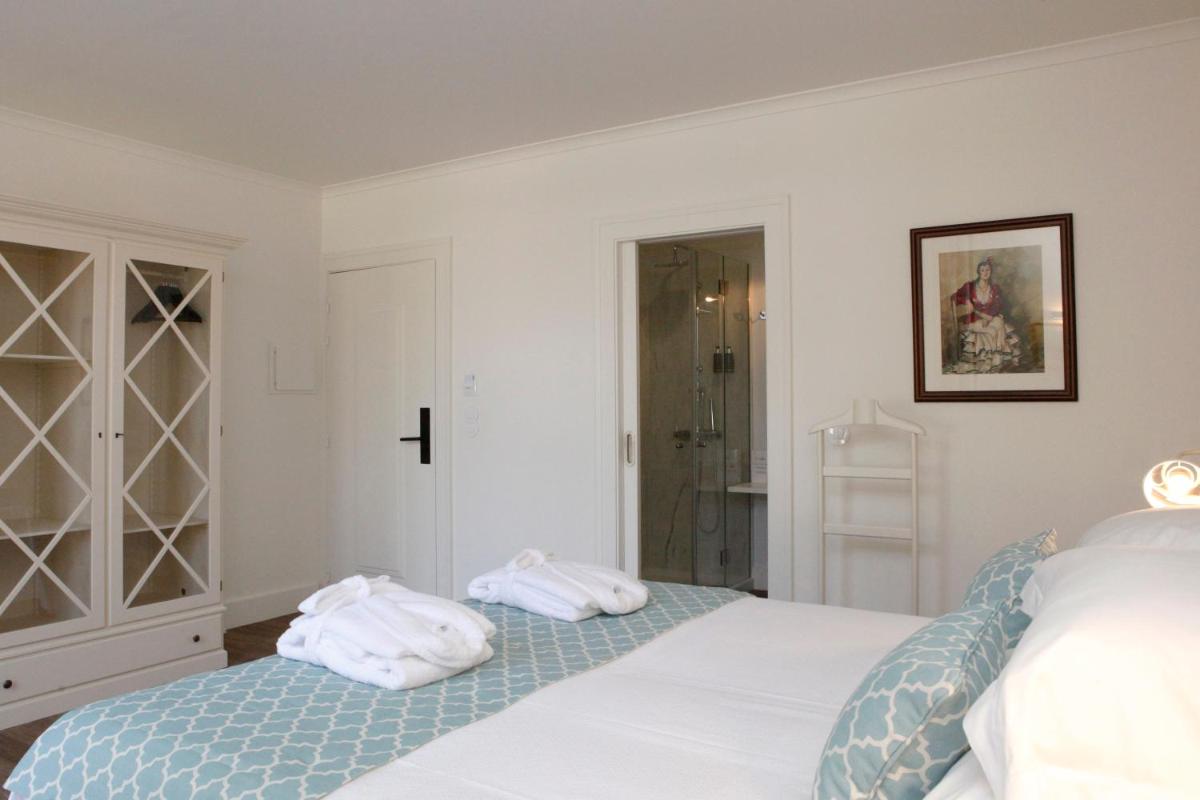Uma cama ou camas num quarto em Hotel Casa Palmela - Small Luxury Hotels of The World, Hotel & Villas