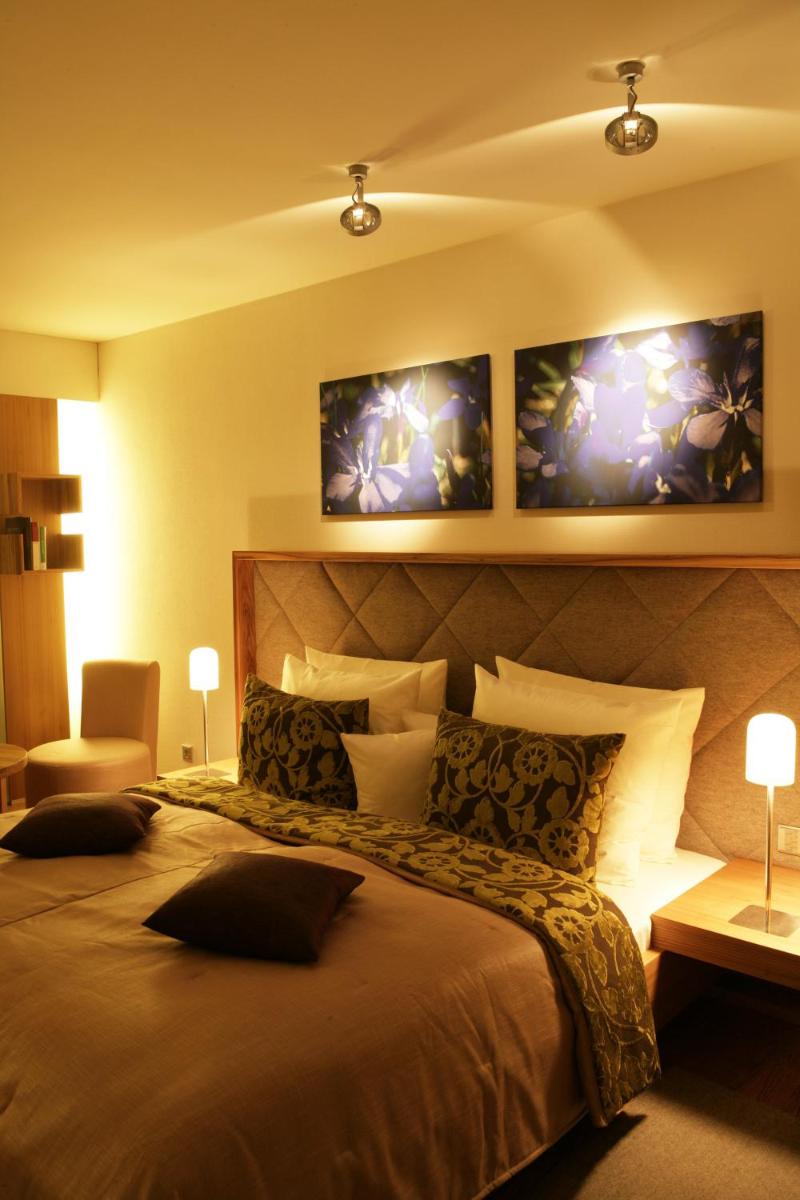 Ein Bett oder Betten in einem Zimmer der Unterkunft Hotel Maximilian