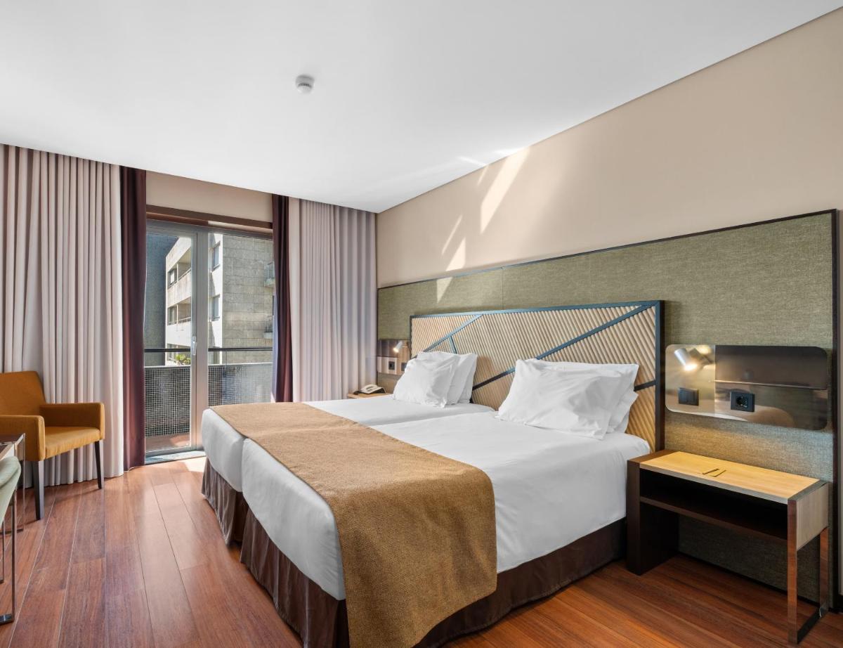 Uma cama ou camas num quarto em Axis Porto Business & Spa Hotel