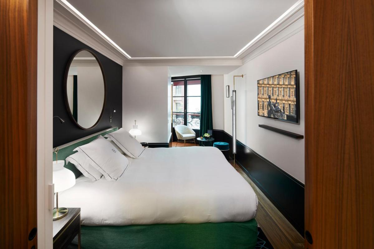 Un ou plusieurs lits dans un hébergement de l'établissement Le Roch Hotel & Spa