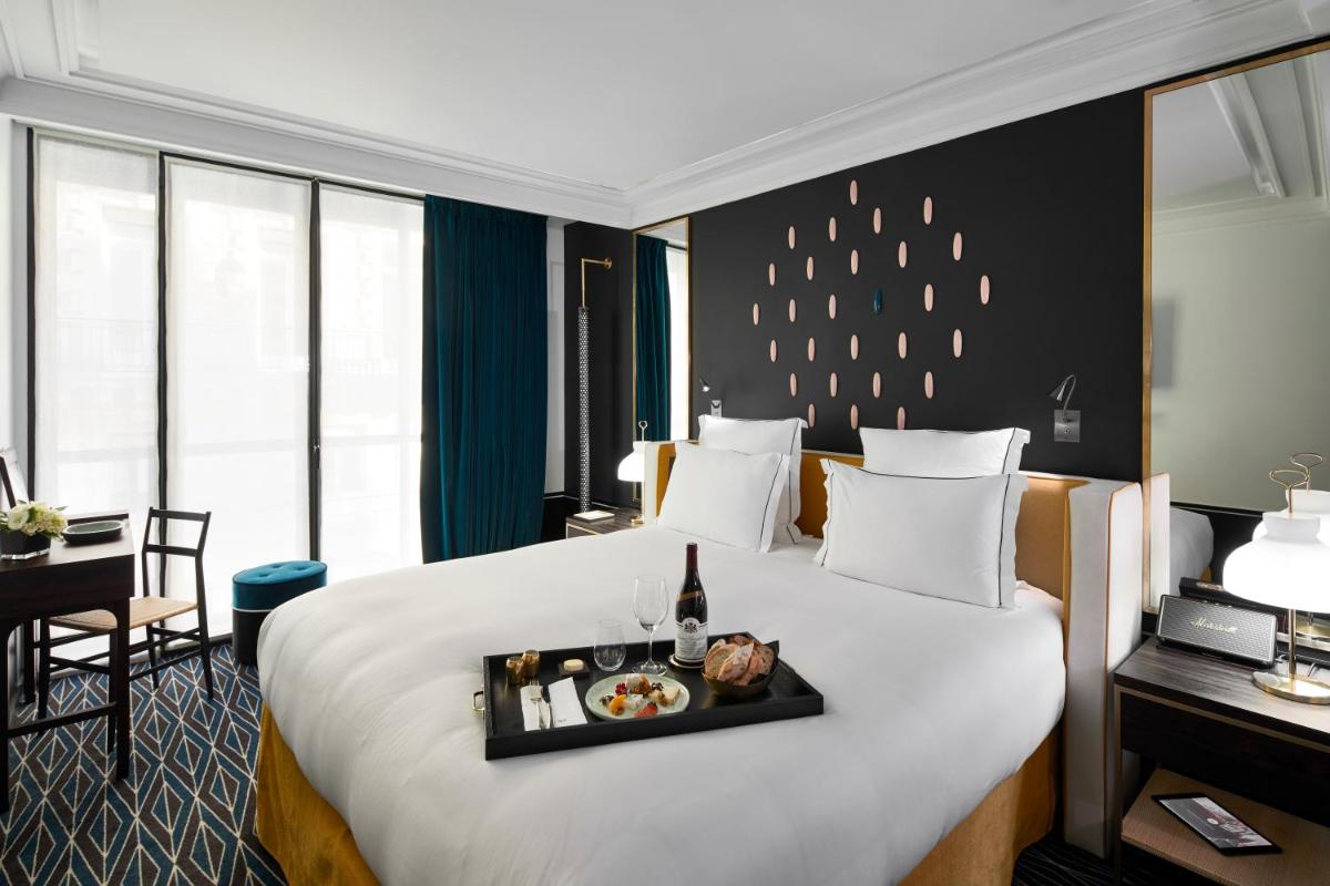 Un ou plusieurs lits dans un hébergement de l'établissement Le Roch Hotel & Spa