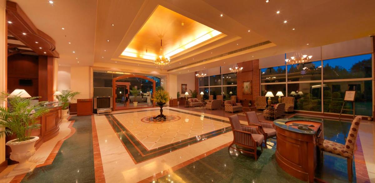 a lobby of a hotel with a lot of furniture at Hotel Royal Orchid Bangalore in Bengaluru