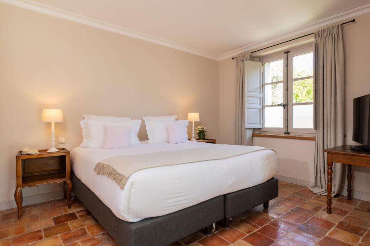 Un ou plusieurs lits dans un hébergement de l'établissement Hôtel - Restaurant & Spa La Magdeleine - Mathias Dandine