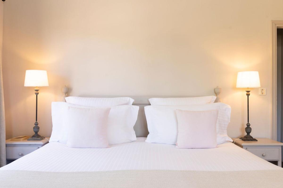 Un ou plusieurs lits dans un hébergement de l'établissement Hôtel - Restaurant & Spa La Magdeleine - Mathias Dandine