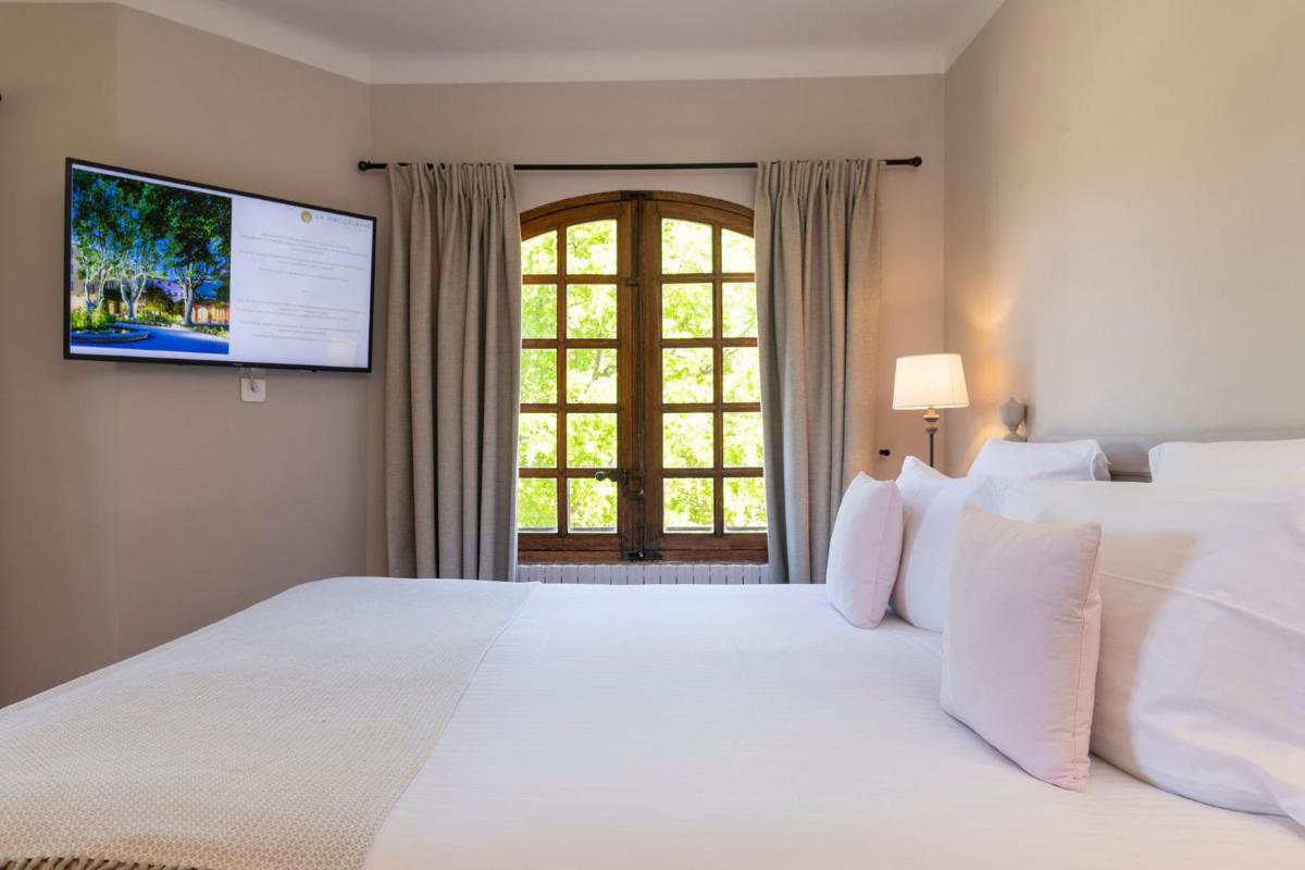 Un ou plusieurs lits dans un hébergement de l'établissement Hôtel - Restaurant & Spa La Magdeleine - Mathias Dandine