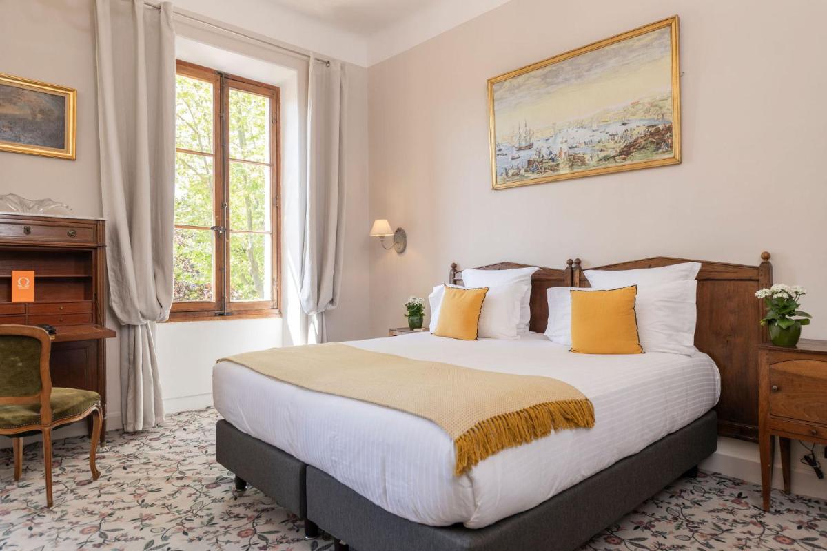 Un ou plusieurs lits dans un hébergement de l'établissement Hôtel - Restaurant & Spa La Magdeleine - Mathias Dandine