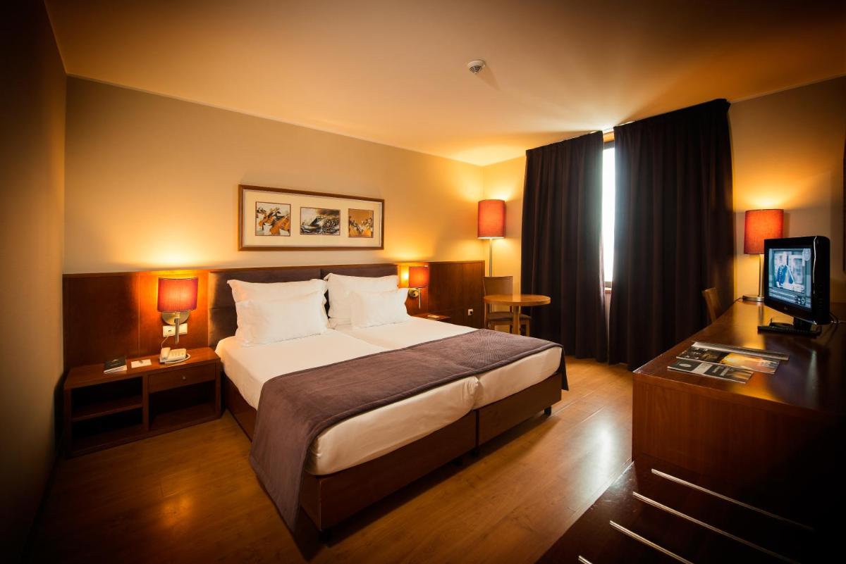 Uma cama ou camas num quarto em Vila Gale Opera