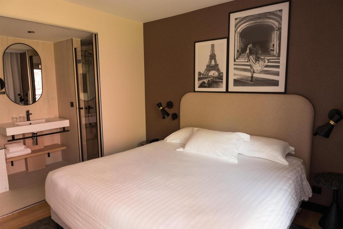 Un ou plusieurs lits dans un hébergement de l'établissement Le Relais de La Malmaison, a member of Radisson Individuals
