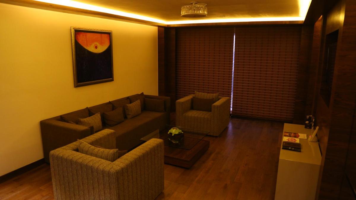 a living room with a couch and two chairs at The Lalit Chandigarh in Chandīgarh