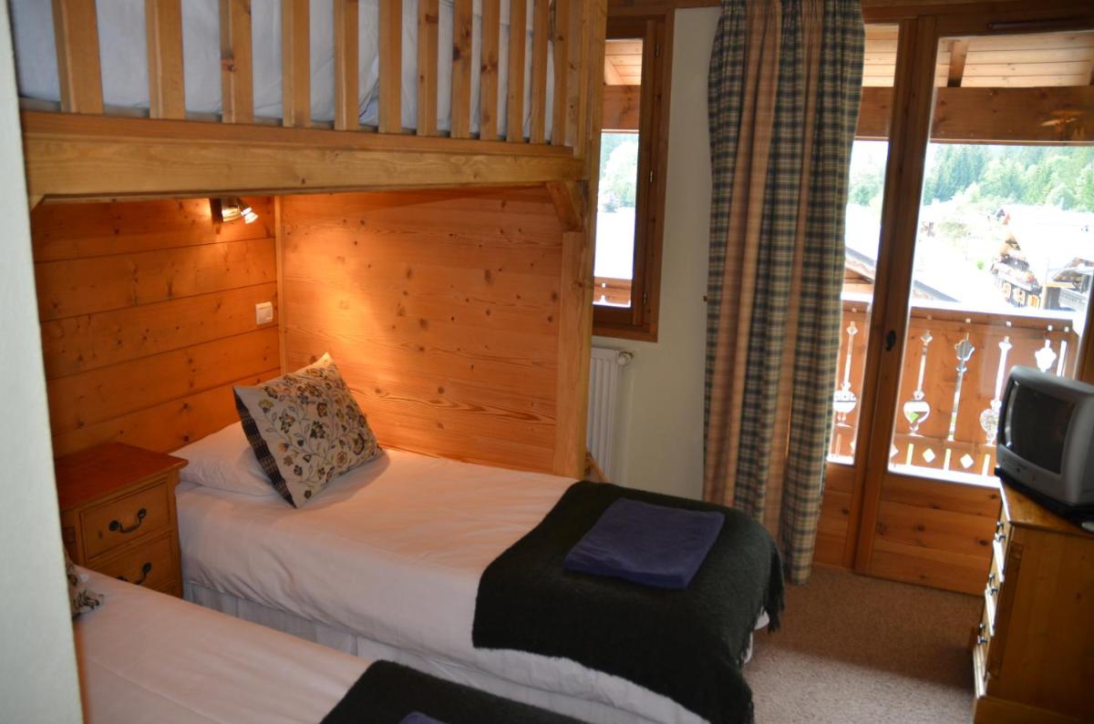 Un ou plusieurs lits dans un hébergement de l'établissement Hôtel et Chalet Au Coin Du Feu Chilly Powder