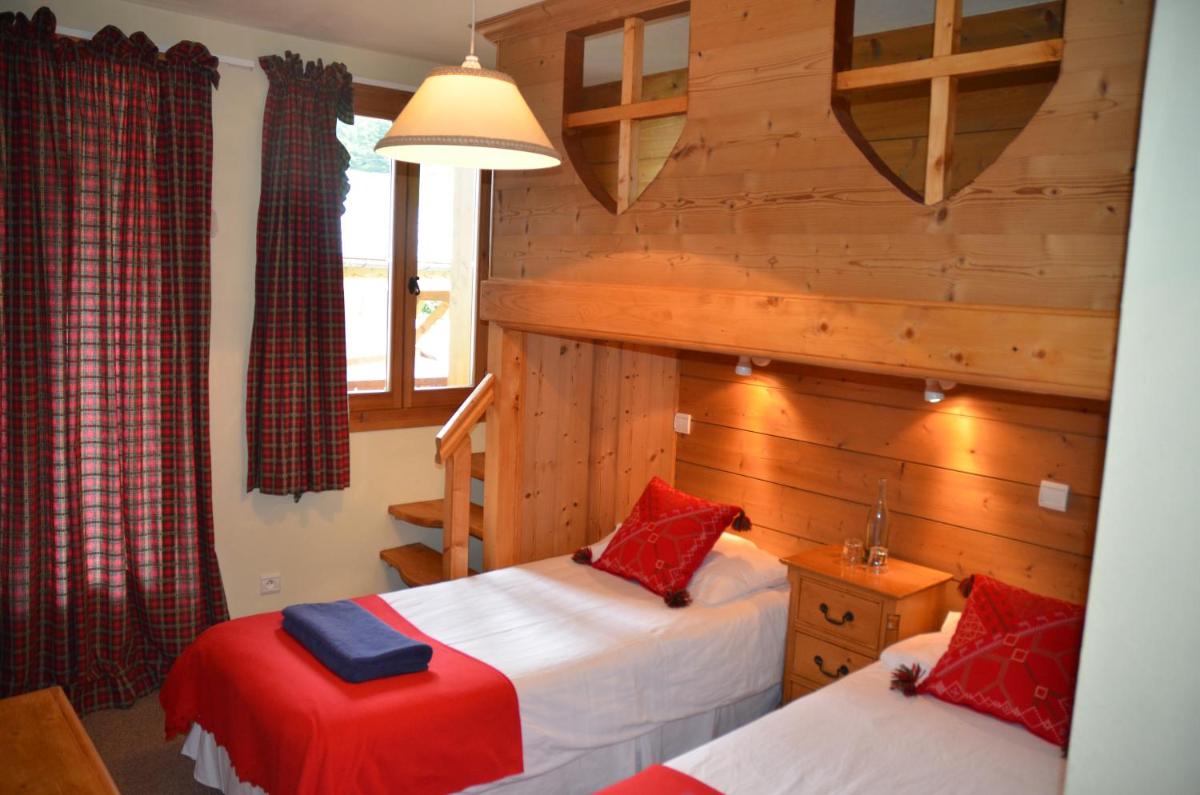 Un ou plusieurs lits dans un hébergement de l'établissement Hôtel et Chalet Au Coin Du Feu Chilly Powder