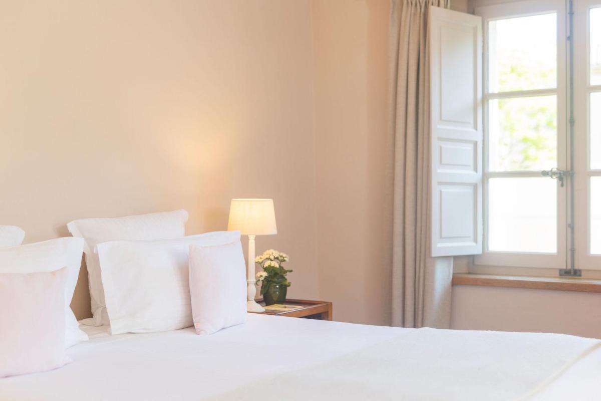 Un ou plusieurs lits dans un hébergement de l'établissement Hôtel - Restaurant & Spa La Magdeleine - Mathias Dandine