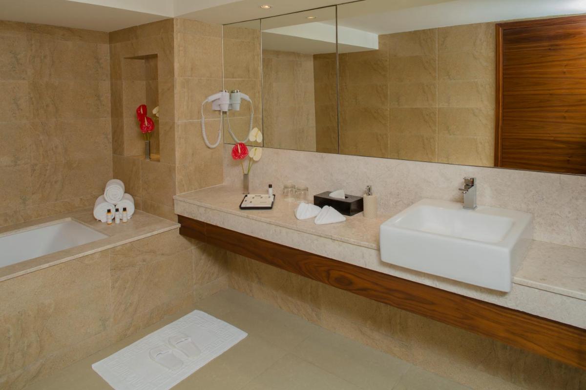 a bathroom with a sink and a mirror at The Raviz Calicut in Kozhikode