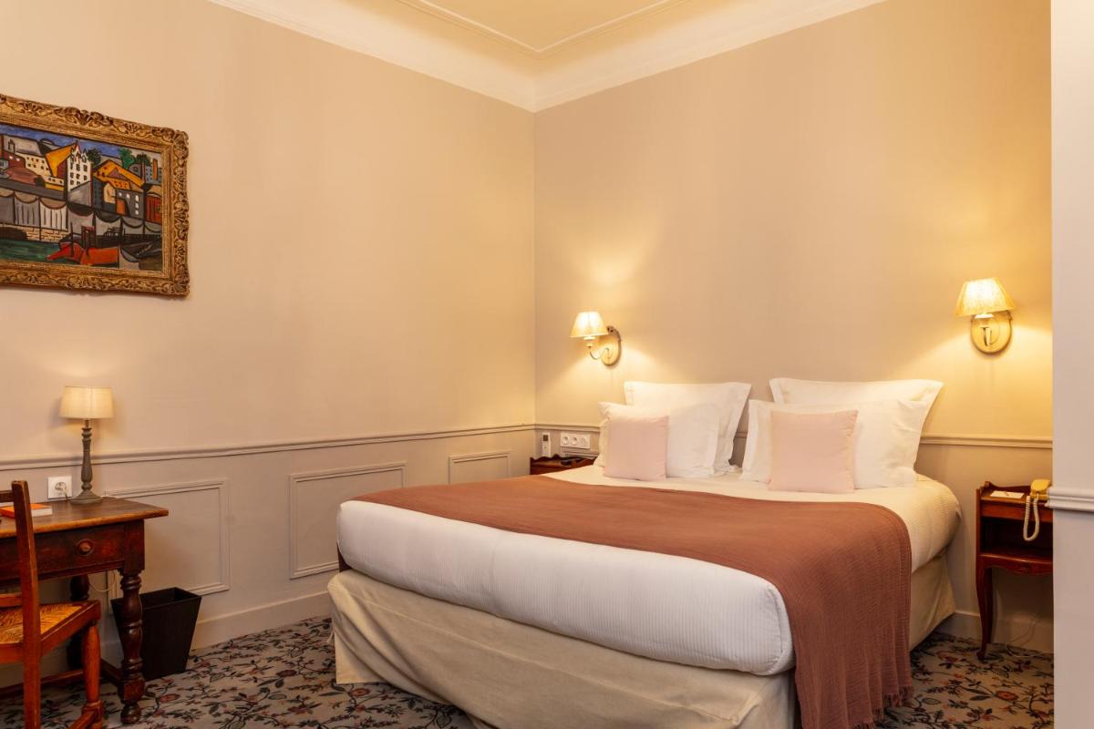 Un ou plusieurs lits dans un hébergement de l'établissement Hôtel - Restaurant & Spa La Magdeleine - Mathias Dandine