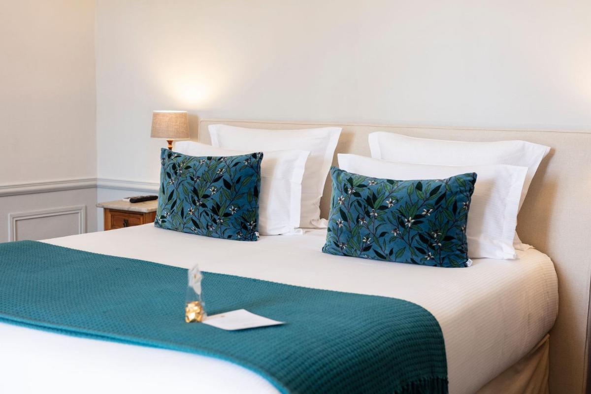 Un ou plusieurs lits dans un hébergement de l'établissement Hôtel - Restaurant & Spa La Magdeleine - Mathias Dandine