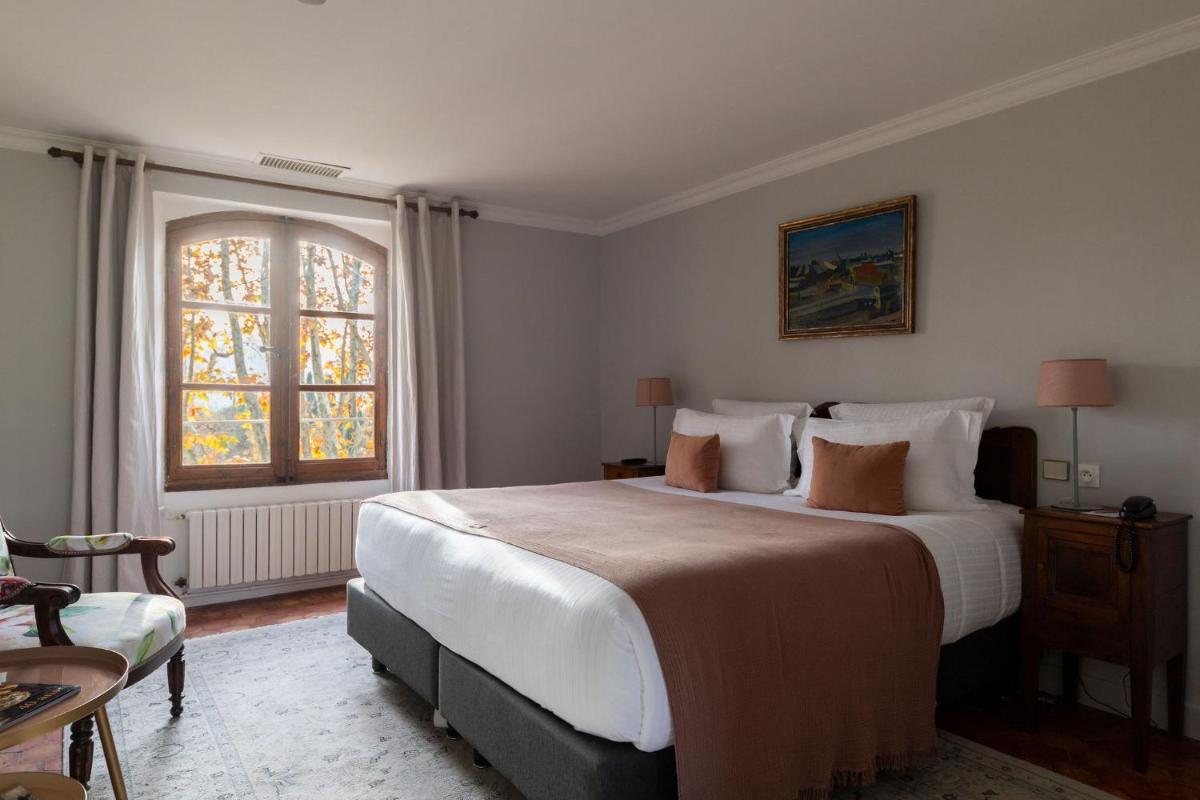 Un ou plusieurs lits dans un hébergement de l'établissement Hôtel - Restaurant & Spa La Magdeleine - Mathias Dandine