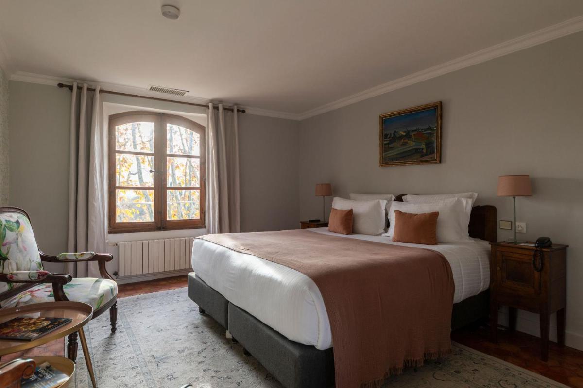 Un ou plusieurs lits dans un hébergement de l'établissement Hôtel - Restaurant & Spa La Magdeleine - Mathias Dandine