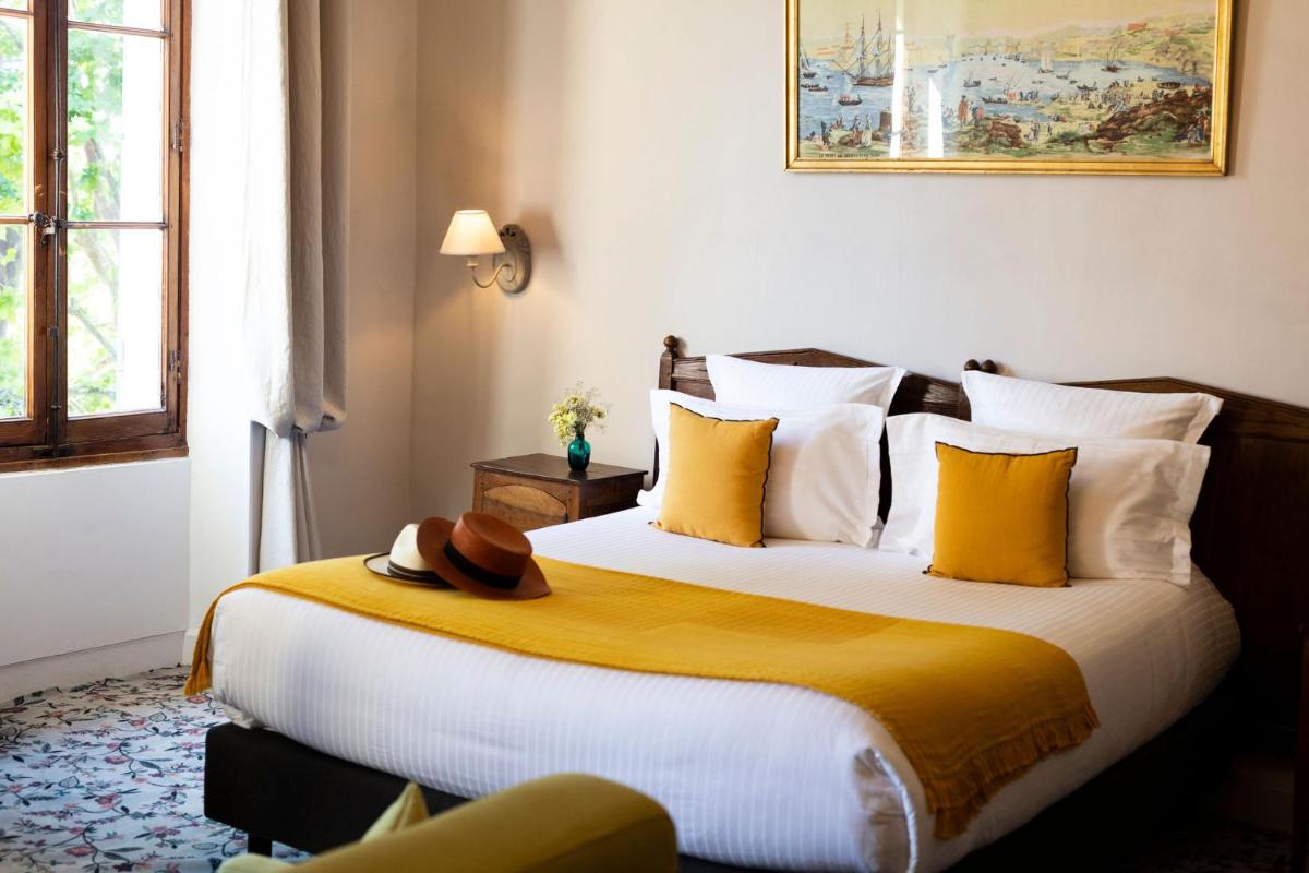Un ou plusieurs lits dans un hébergement de l'établissement Hôtel - Restaurant & Spa La Magdeleine - Mathias Dandine