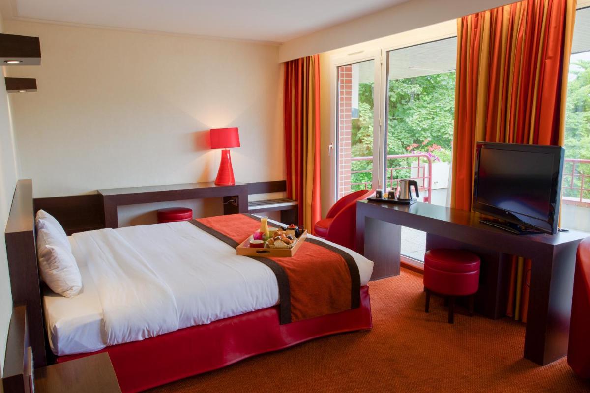 Un ou plusieurs lits dans un hébergement de l'établissement Hôtel Spa Du Béryl