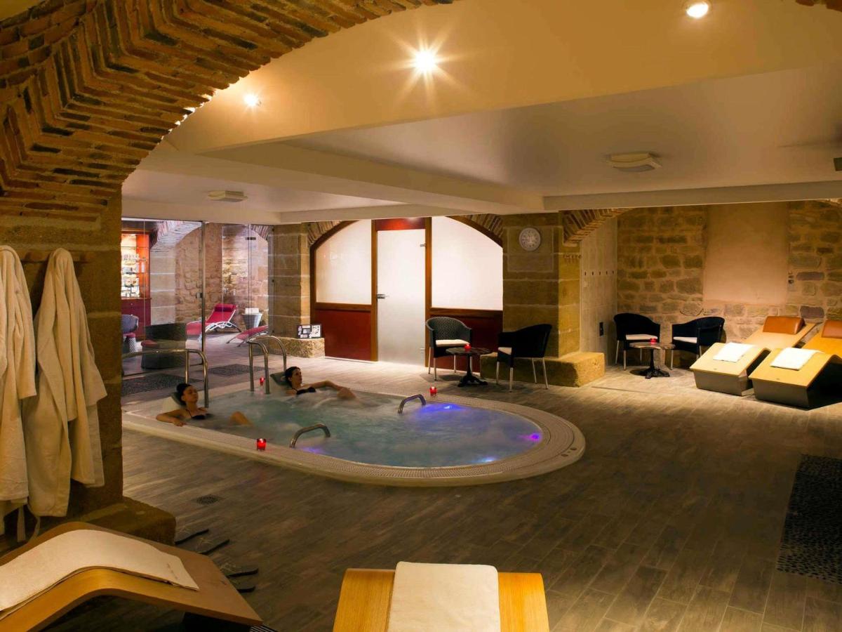 une chambre d'hôtel avec un jacuzzi occupé par des gens dans l'établissement Mercure Moulins Centre Hôtel de Paris, à Moulins