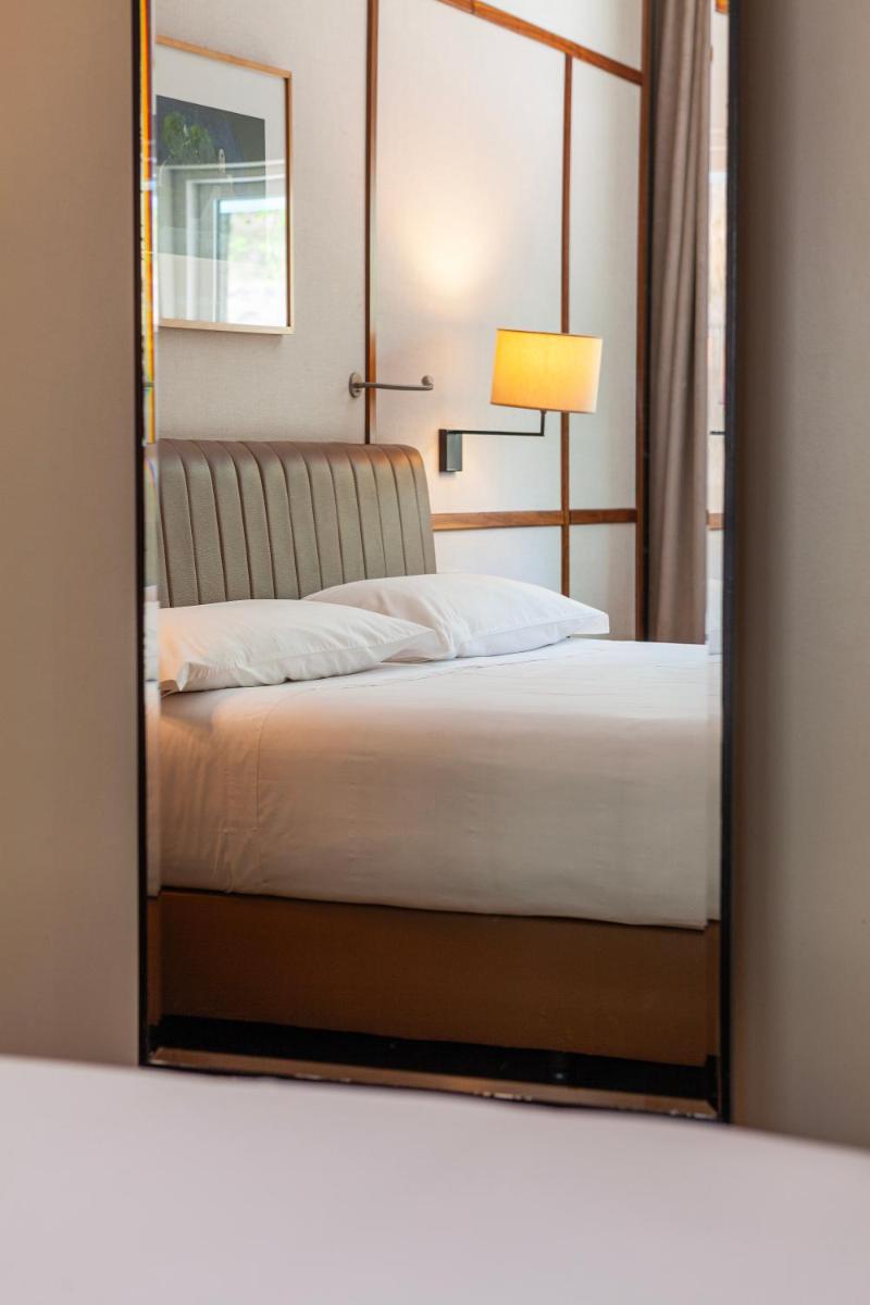 Uma cama ou camas num quarto em Hotel de Guimaraes Business & SPA