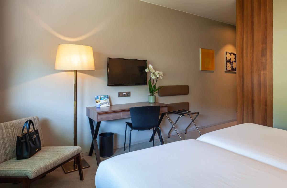 Uma cama ou camas num quarto em Hotel de Guimaraes Business & SPA