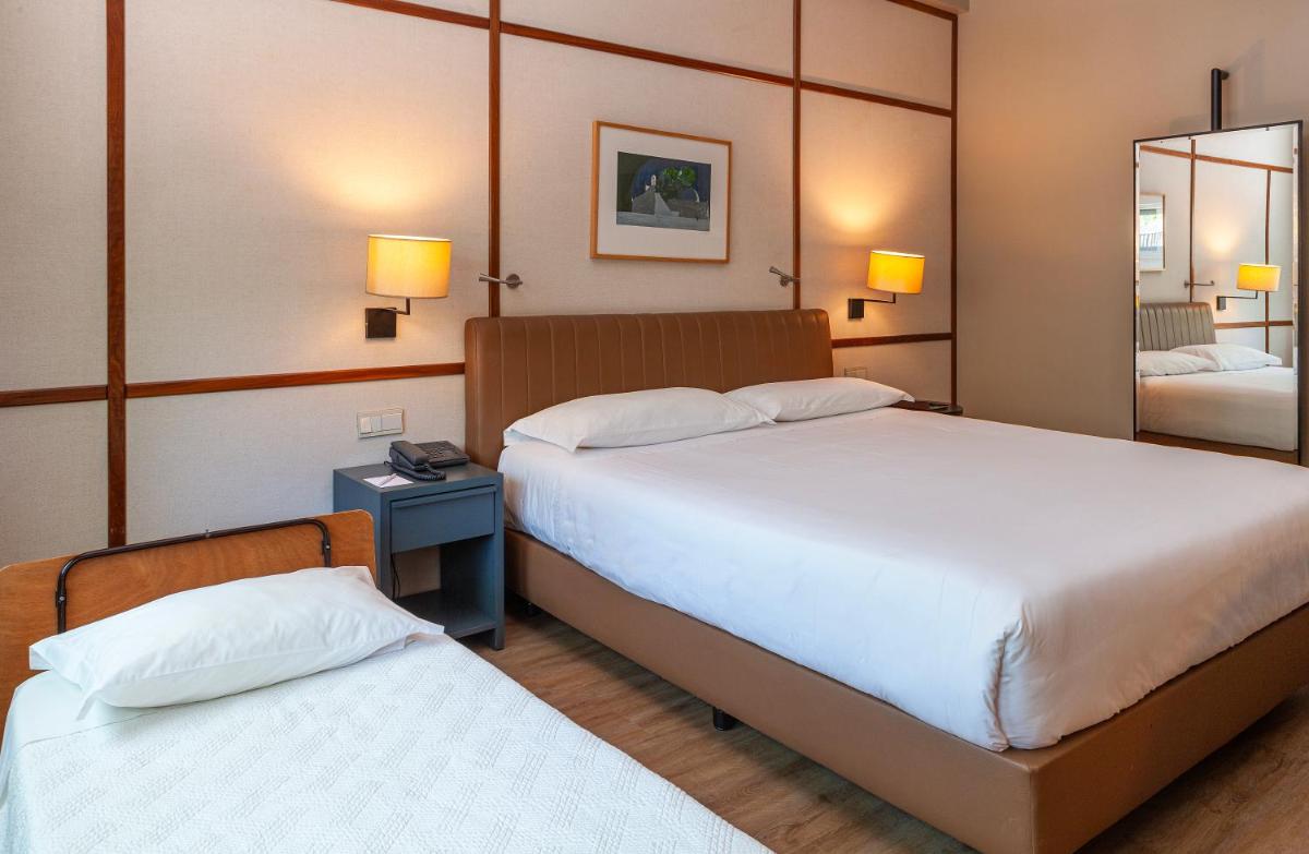 Uma cama ou camas num quarto em Hotel de Guimaraes Business & SPA