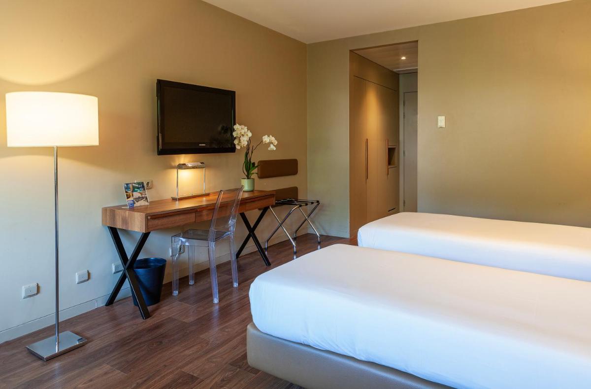 Uma cama ou camas num quarto em Hotel de Guimaraes Business & SPA