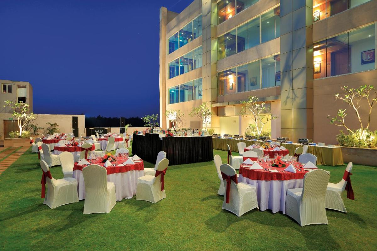 a group of tables and chairs in front of a building at Yashail Hotel Haridwar in Haridwār +40 photos