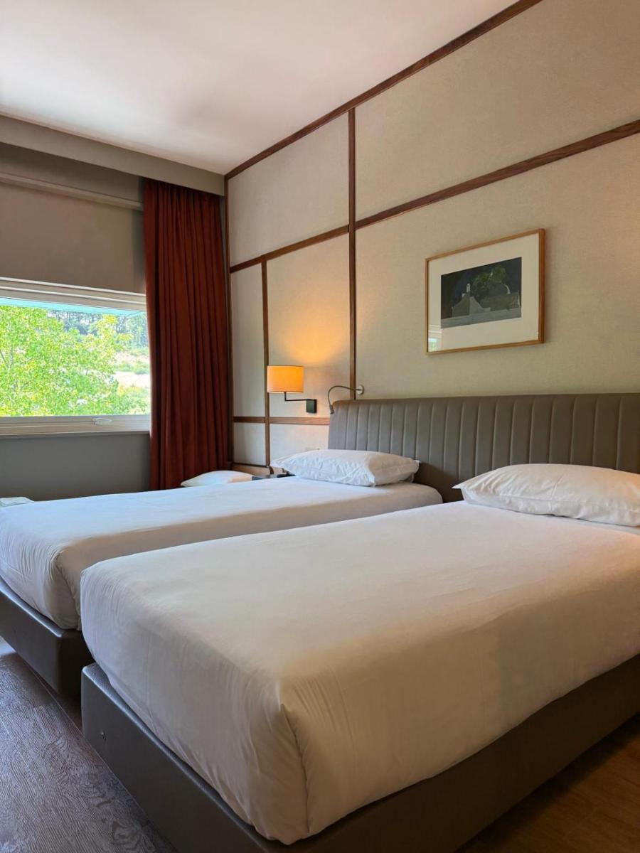 Uma cama ou camas num quarto em Hotel de Guimaraes Business & SPA
