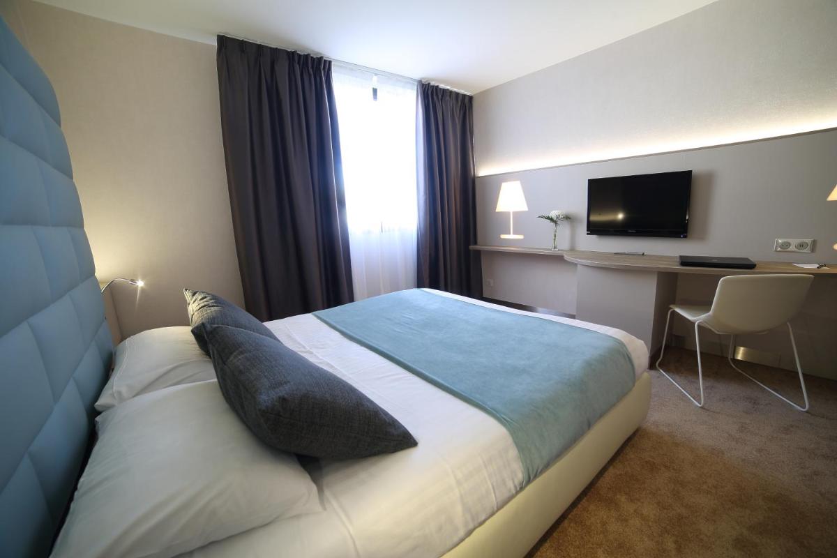 Un ou plusieurs lits dans un hébergement de l'établissement Hotel Plaza - site du Futuroscope
