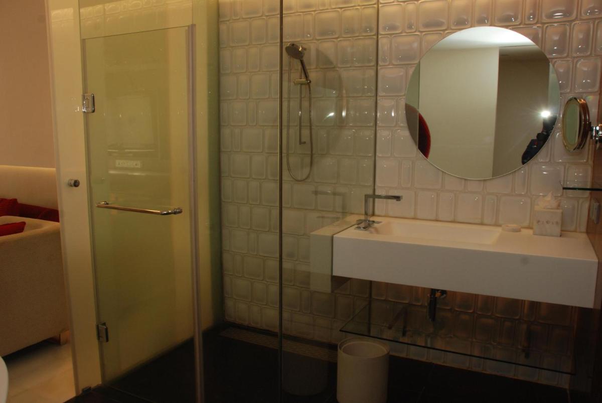 a bathroom with a shower and a sink and a mirror at The Park Hyderabad, Banjara Hills near Hussain Sagar Lake in Hyderabad a bathroom with a shower and a sink and a mirror at The Park Hyderabad, Banjara Hills near Hussain Sagar Lake in Hyderabad
