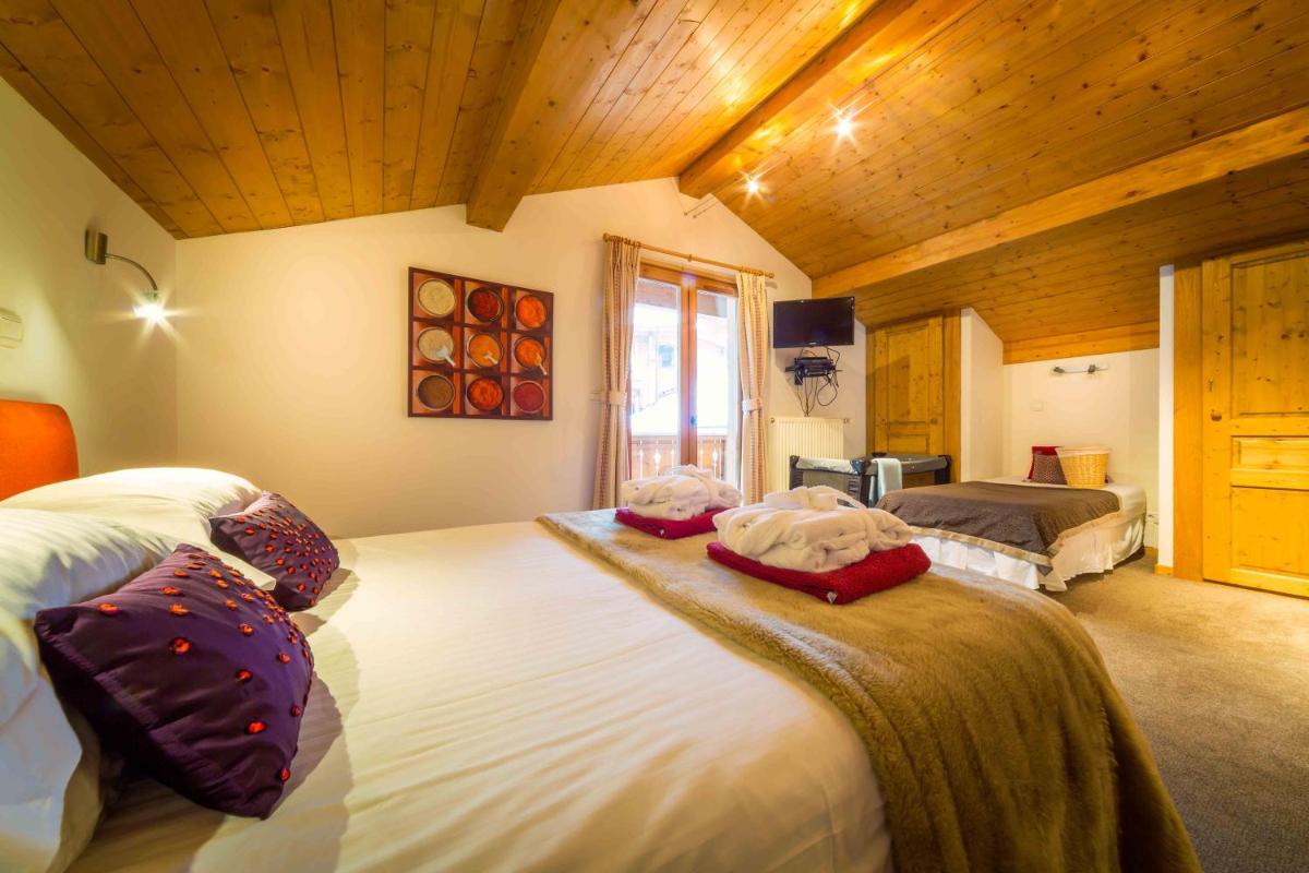 Un ou plusieurs lits dans un hébergement de l'établissement Hôtel et Chalet Au Coin Du Feu Chilly Powder