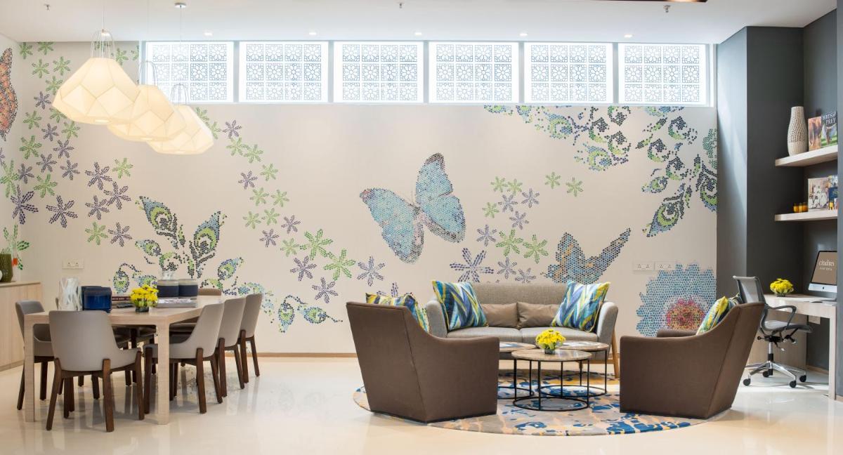a dining room with butterflies on the wall at Citadines OMR Chennai in Chennai a dining room with butterflies on the wall at Citadines OMR Chennai in Chennai