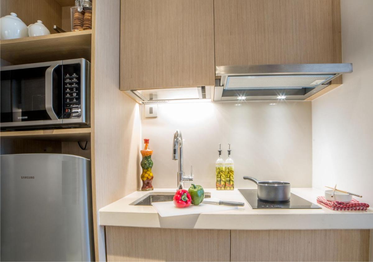 a kitchen with a sink and a microwave at Citadines OMR Chennai in Chennai a kitchen with a sink and a microwave at Citadines OMR Chennai in Chennai