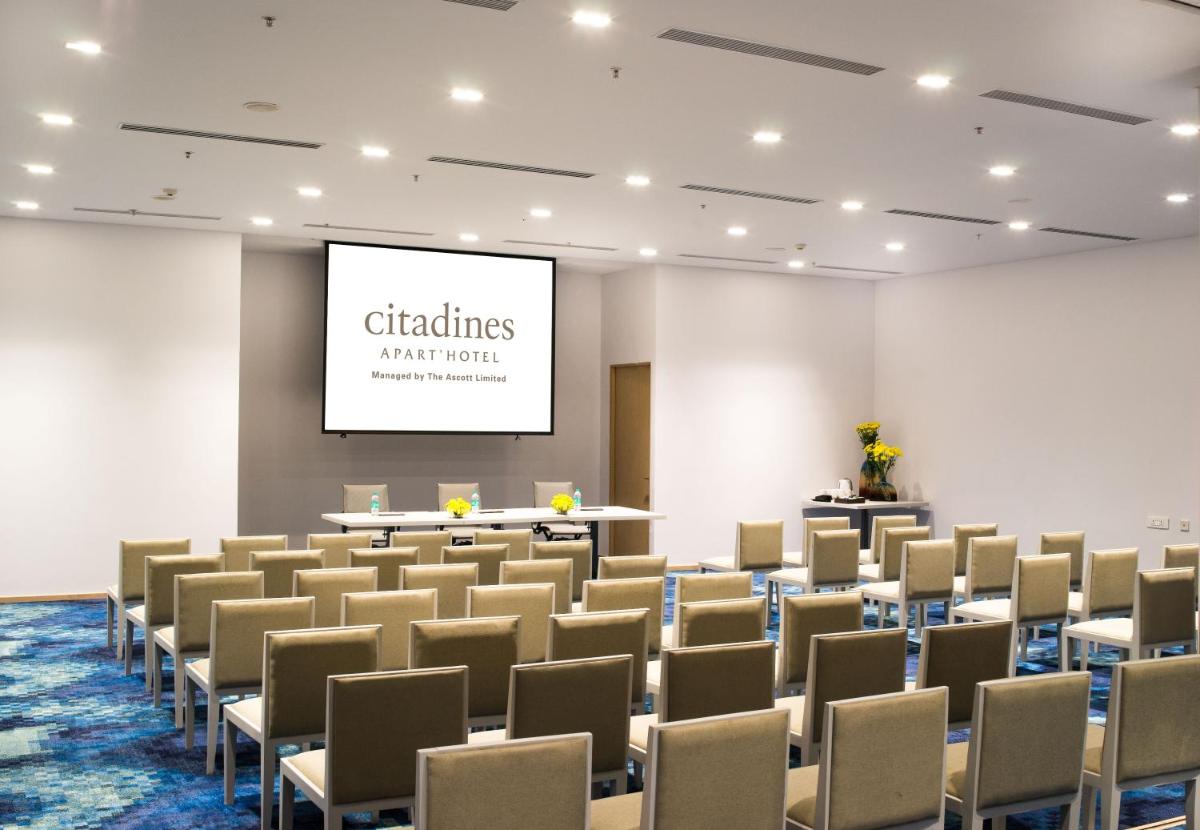 a conference room with chairs and a projection screen at Citadines OMR Chennai in Chennai a conference room with chairs and a projection screen at Citadines OMR Chennai in Chennai