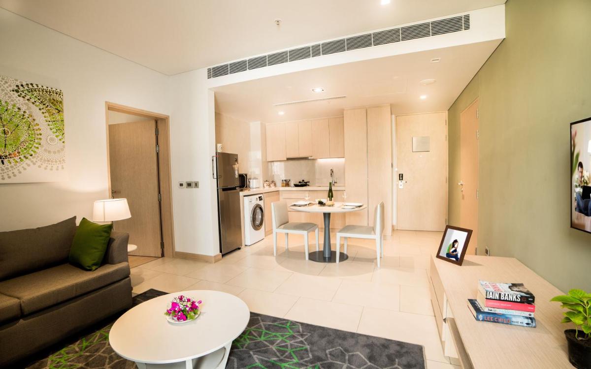 a living room with a couch and a table at Citadines OMR Chennai in Chennai a living room with a couch and a table at Citadines OMR Chennai in Chennai