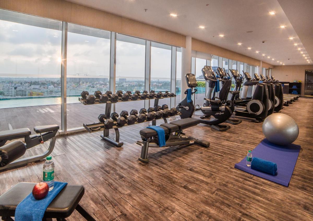 a gym with treadmills and machines in a building at Citadines OMR Chennai in Chennai a gym with treadmills and machines in a building at Citadines OMR Chennai in Chennai
