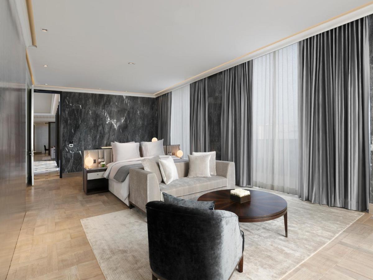 a living room with a couch and a bed at Roseate House New Delhi in New Delhi a living room with a couch and a bed at Roseate House New Delhi in New Delhi