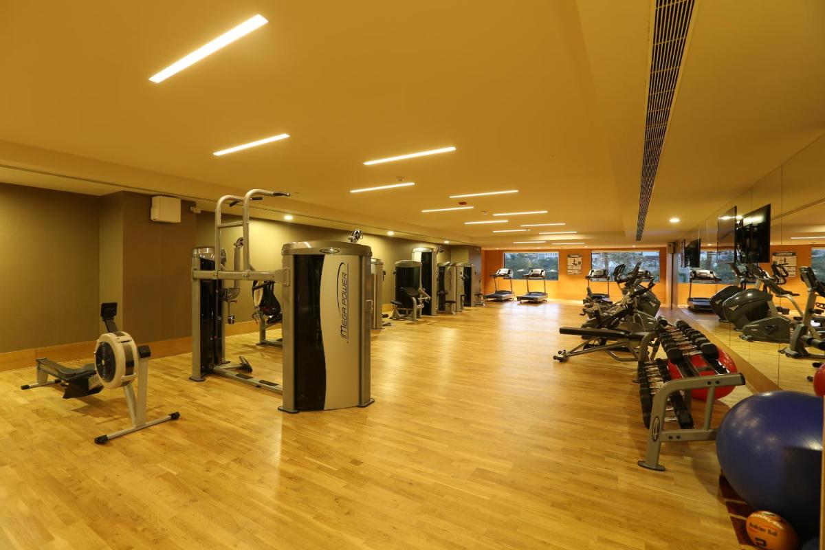 a gym with a bunch of exercise equipment in a room at Feathers- A Radha Hotel, Chennai in Chennai