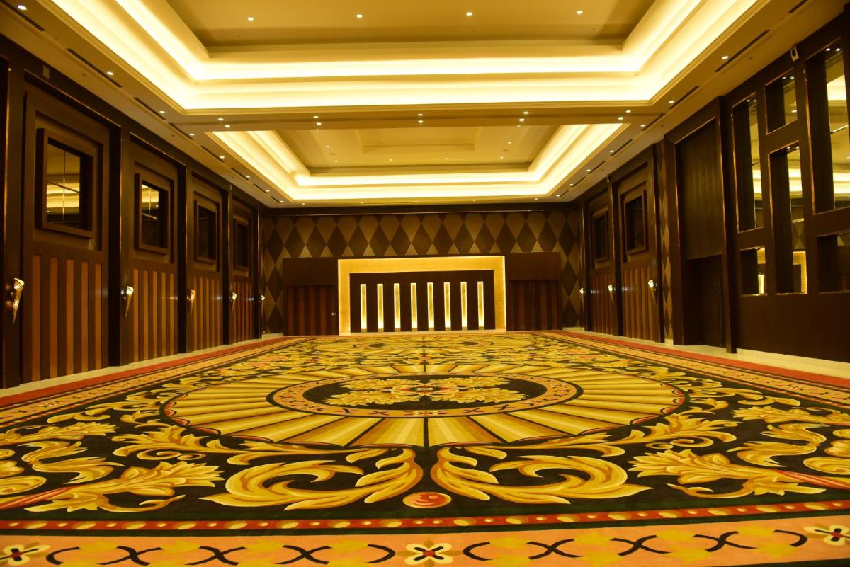 a large room with a large rug on the floor at Ramada by Wyndham Lucknow Hotel and Convention Center in Lucknow