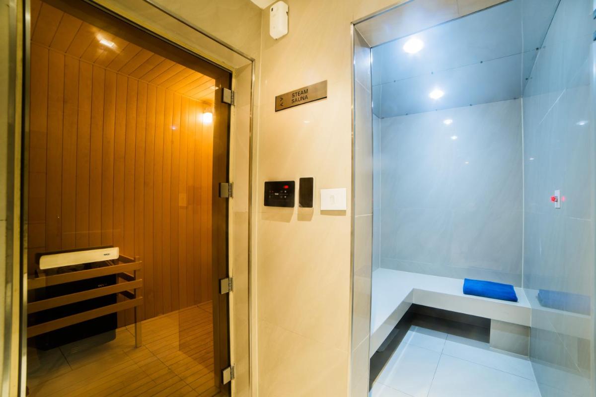 a shower in a bathroom with a glass door at Citadines OMR Chennai in Chennai a shower in a bathroom with a glass door at Citadines OMR Chennai in Chennai