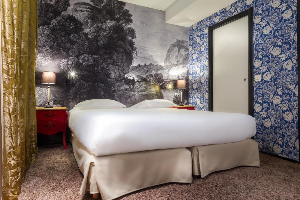 Un ou plusieurs lits dans un hébergement de l'établissement Hotel L’Antoine