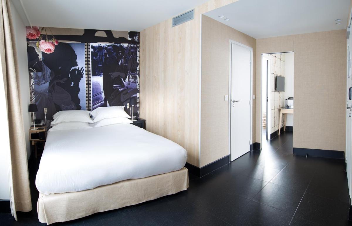 Un ou plusieurs lits dans un hébergement de l'établissement Hotel L’Antoine