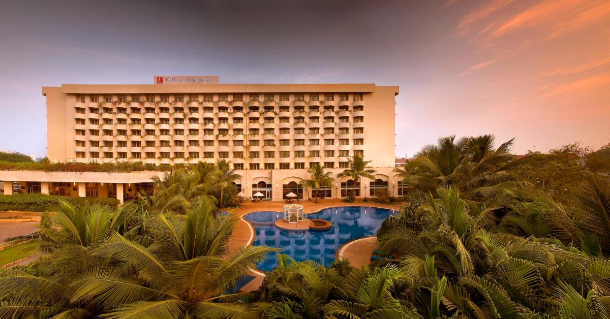 a hotel with a pool in front of a building at The Lalit Mumbai in Mumbai