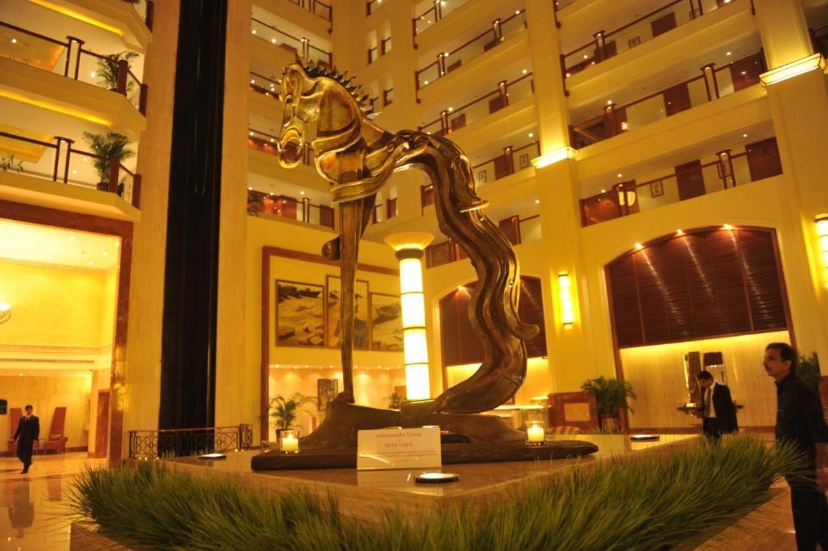 a statue in the lobby of a hotel at The Lalit Mumbai in Mumbai